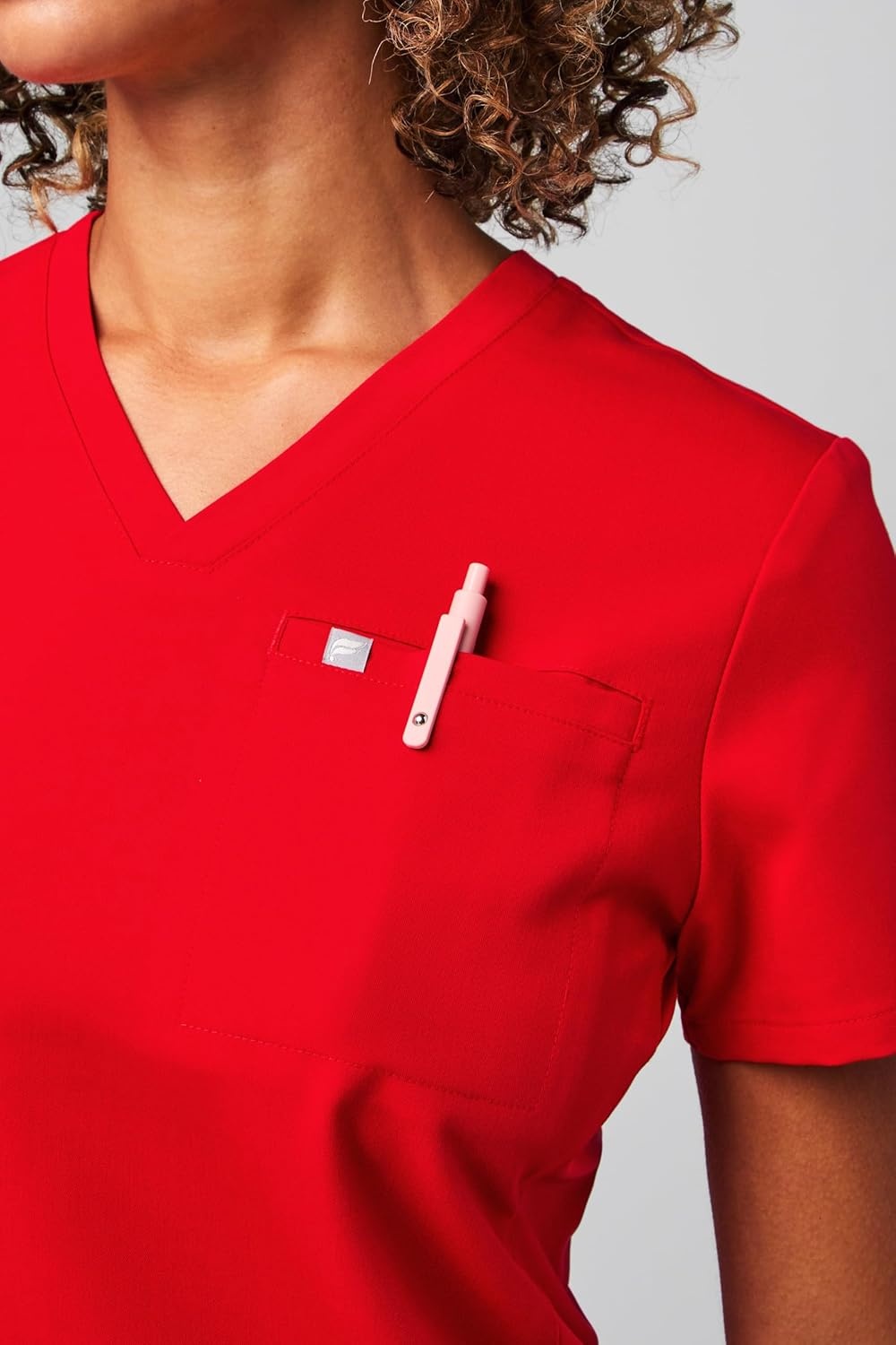 image:imageFabletics Womens Vital 1Pocket Scrub Top MotionTech WrinkleResist Chest Pocket AntiShrink SemiSlim FitGoji Red