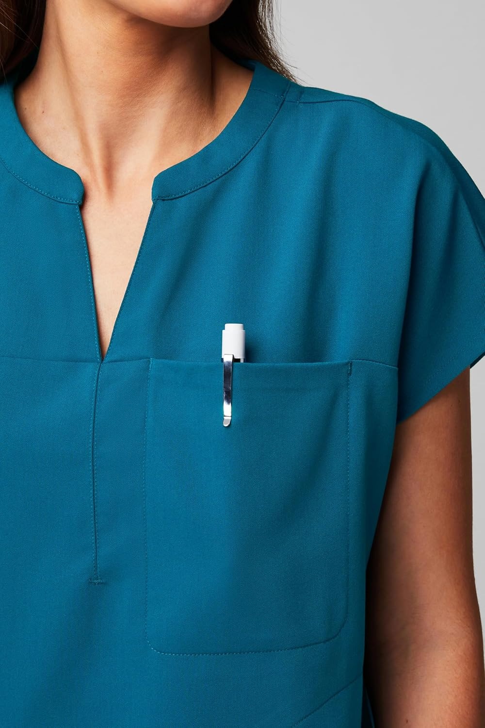 image:imageFabletics Womens Evolve 3Pocket Scrub Top with an Oversized Fit MotionTech 4Way Stretch WrinkleResist AntiShrinkCaribbean Blue