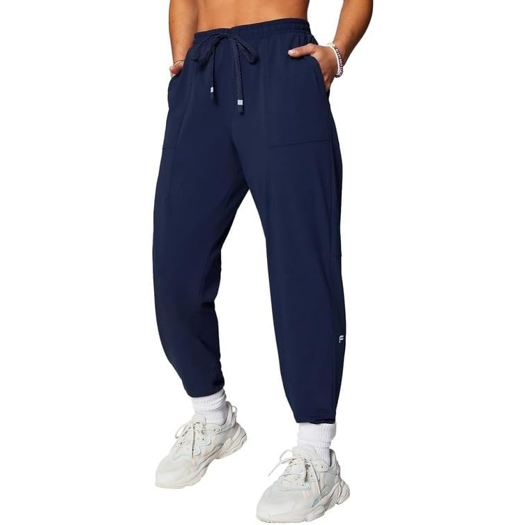 image:imageFabletics Womens The One Jogger QuickDry Hidden Pockets Zip Pockets UPF Protection AntiStink LightweightDeep Navy