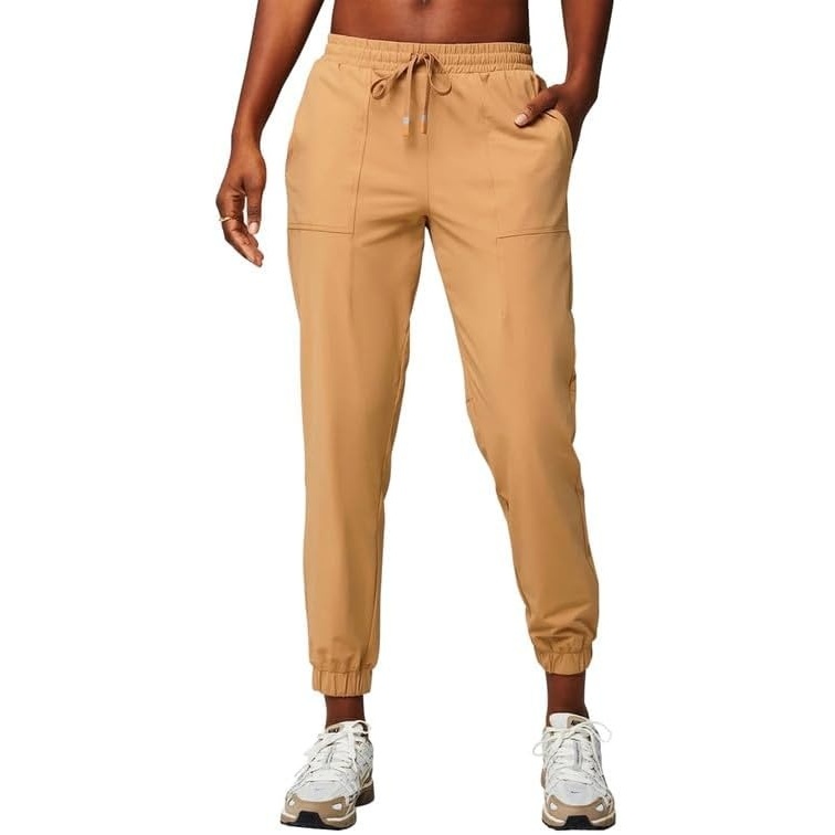 image:imageFabletics Womens The One Jogger QuickDry Hidden Pockets Zip Pockets UPF Protection AntiStink LightweightQuicksand